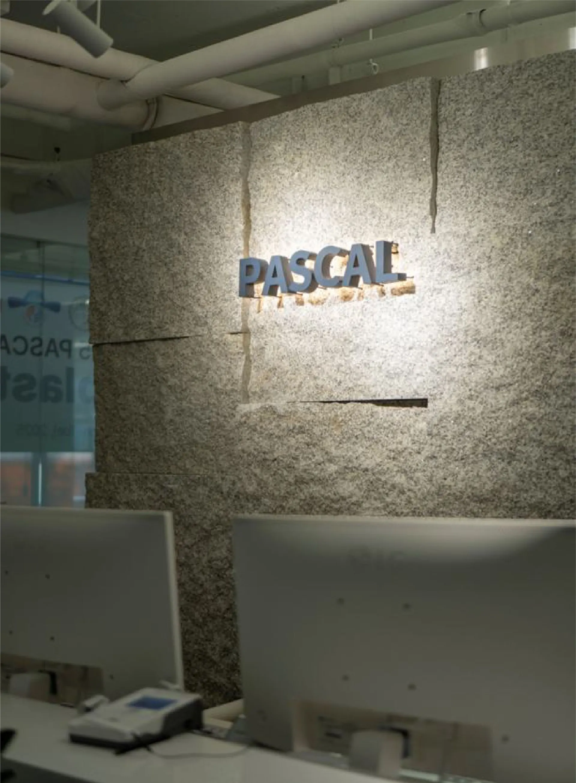 Stone wall with the Pascal logo at the entrance