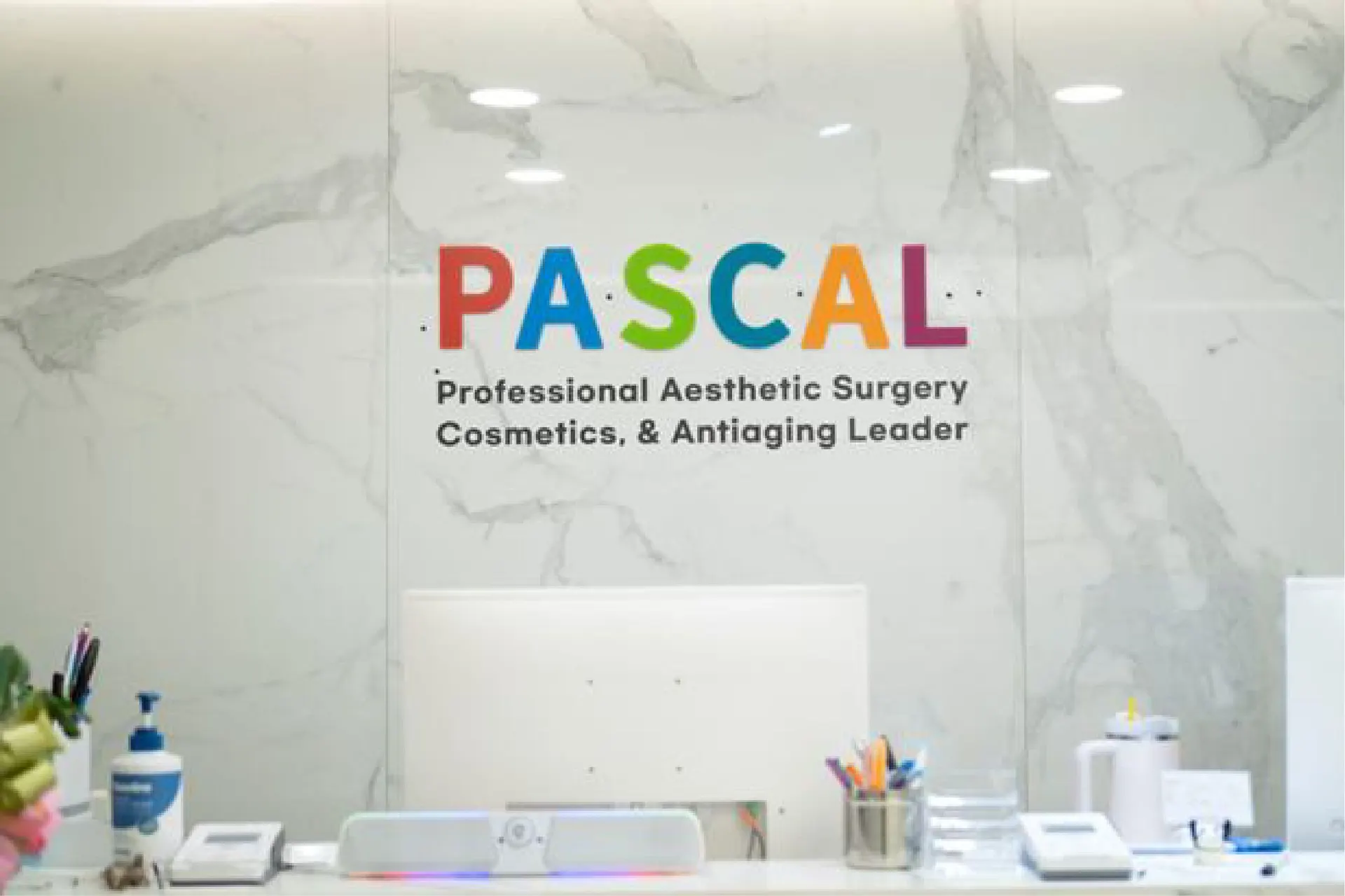 Reception desk with the Pascal logo wall