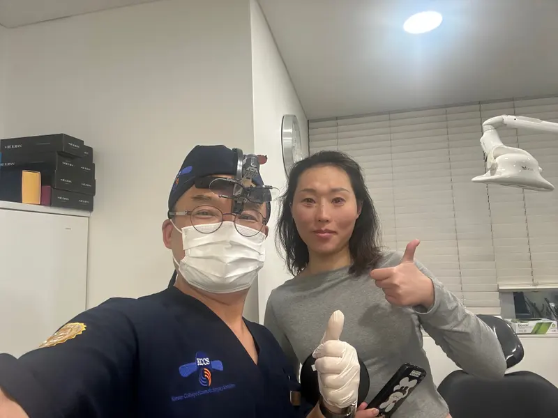 Dr. Kang taking a photo with a patient in a Pascal Clinic exam room, photo 1