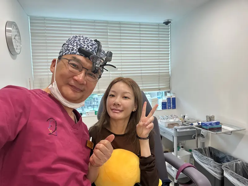 Dr. Kang taking a photo with a patient in a Pascal Clinic exam room, photo 3