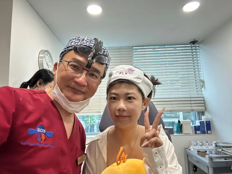 Dr. Kang taking a photo with a patient in a Pascal Clinic exam room, photo 6