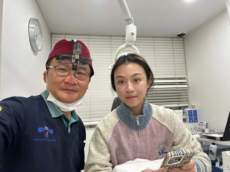 Dr. Kang taking a photo with a patient in a Pascal Clinic exam room, photo 10