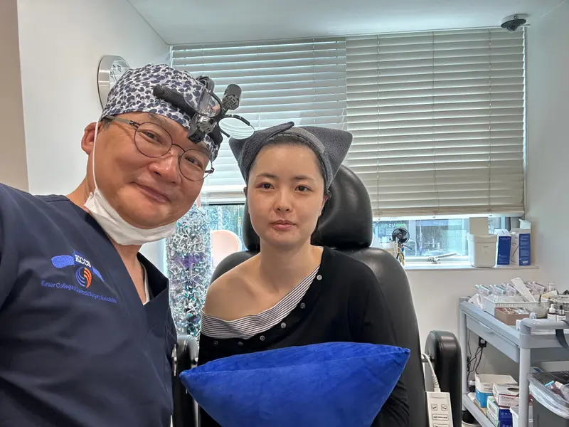 Dr. Kang taking a photo with a patient in a Pascal Clinic exam room, photo 14