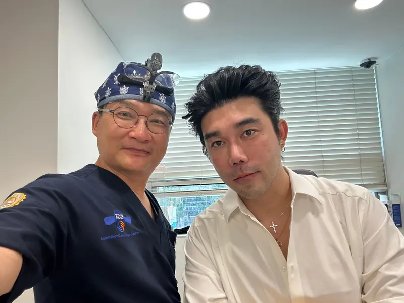 Dr. Kang taking a photo with a patient in a Pascal Clinic exam room, photo 15