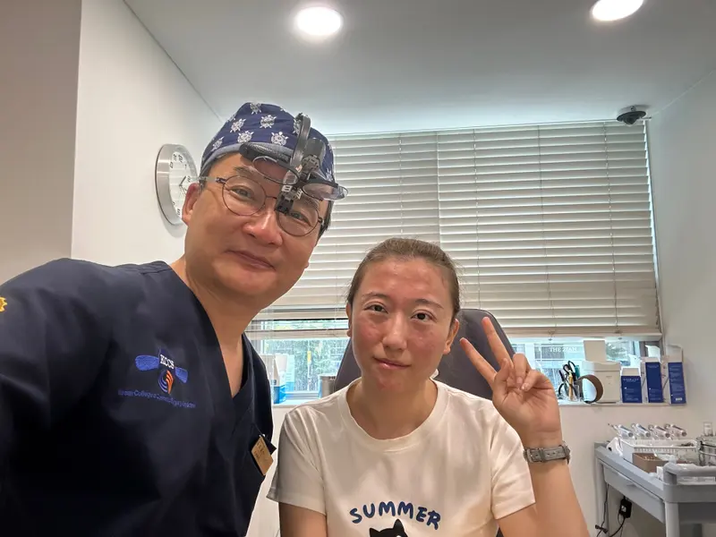 Dr. Kang taking a photo with a patient in a Pascal Clinic exam room, photo 16