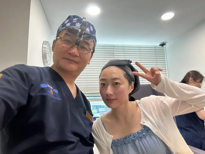Dr. Kang taking a photo with a patient in a Pascal Clinic exam room, photo 17
