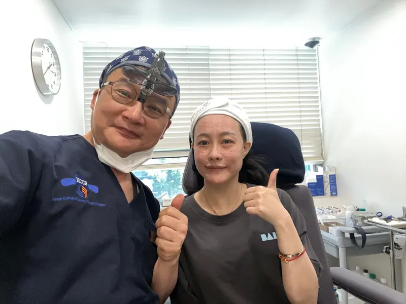Dr. Kang taking a photo with a patient in a Pascal Clinic exam room, photo 19