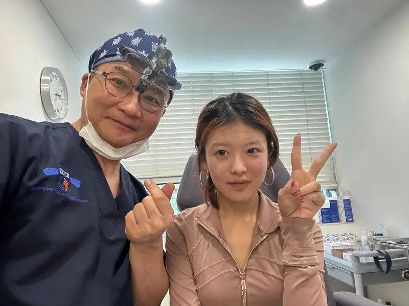 Dr. Kang taking a photo with a patient in a Pascal Clinic exam room, photo 20